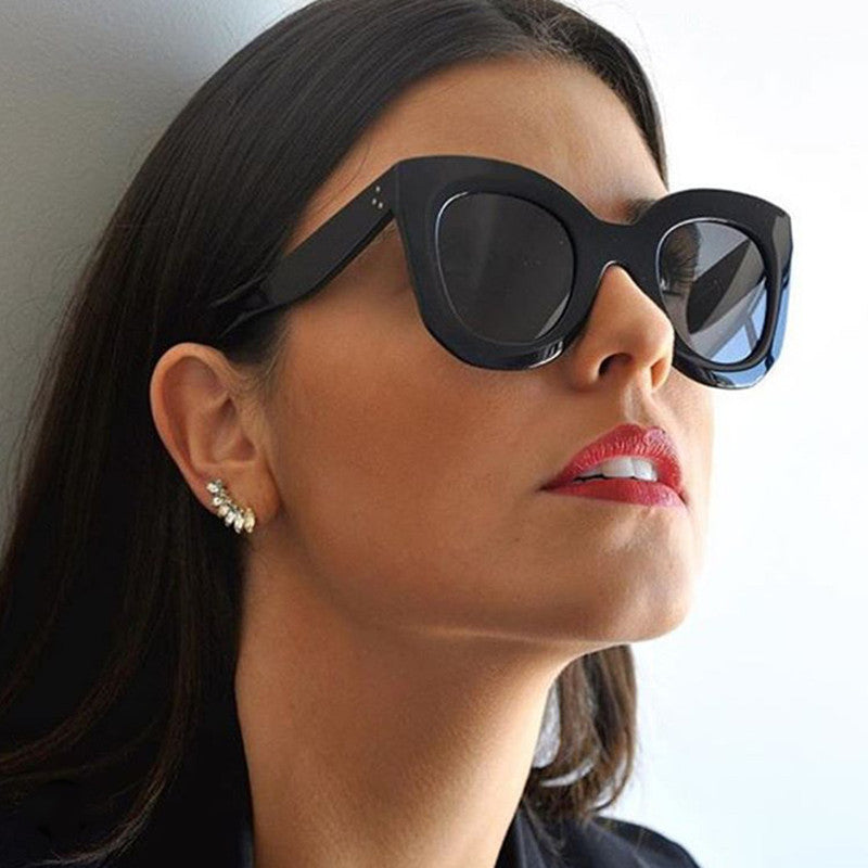 Sunglasses fashion cat eye sunglasses worn by a model with a bold style and striking lip color.