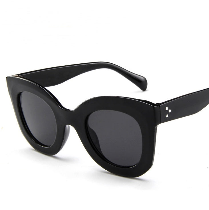 Sunglasses fashion cat eye sunglasses in black with oversized frames and dark lenses.